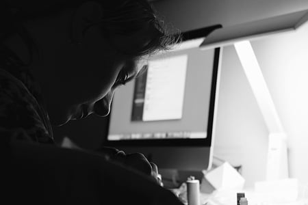 woman leaning beside a turned on iMac thumbnail