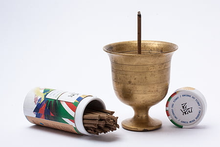 gold cup and brown incense sticks thumbnail