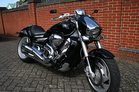 black cruiser motorcycle on gray concrete pavement thumbnail