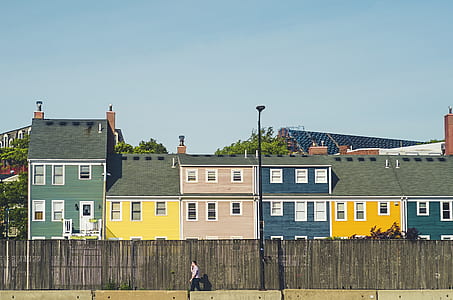 man standing beside brown wooden fence during daytime thumbnail
