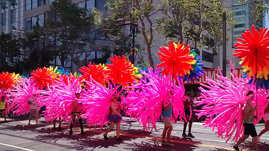 people carrying balloons at the street during daytime thumbnail