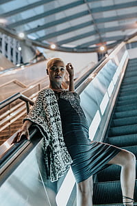 woman wearing black and white dress in escalator thumbnail