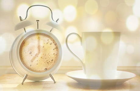white twin bell alarm clock and ceramic mug thumbnail
