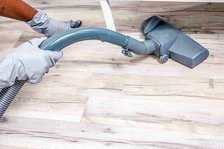 person cleaning floor using vacuum cleaner thumbnail