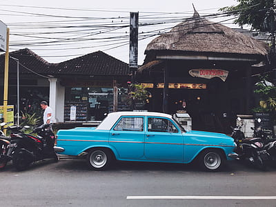 blue sedan parked on asphalt road thumbnail
