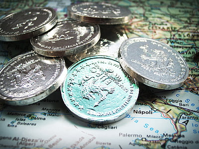 coins on multicolored map thumbnail