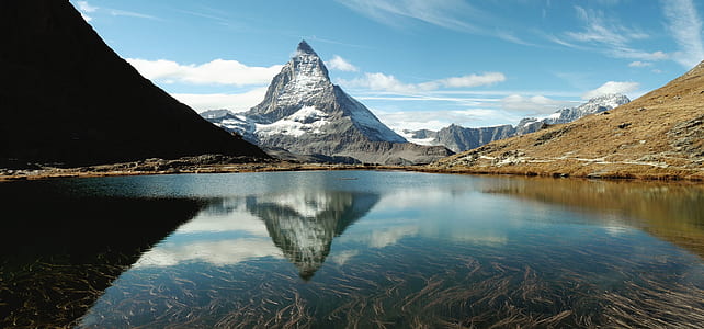 landscape photography of mountain near lake thumbnail