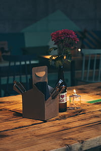 red flowers beside gray box on brown table thumbnail