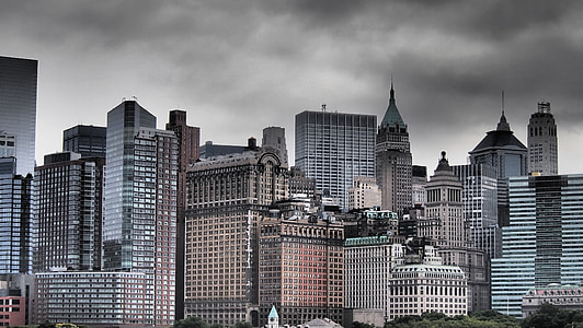 city buildings under gray cloudy sky thumbnail