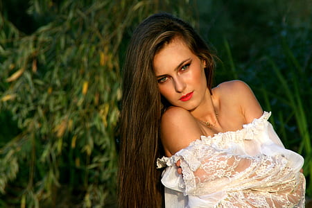 woman in white floral top doing pose thumbnail