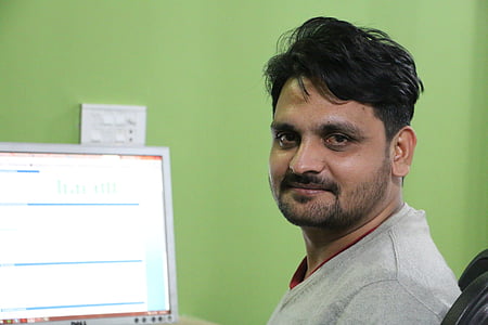 man sitting black chair infront of gray Dell monitor thumbnail