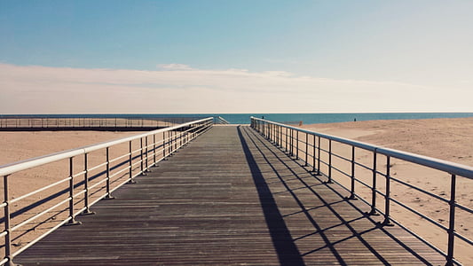 gray wooden dock near ocean thumbnail