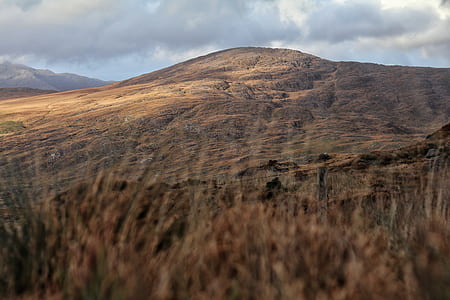 brown mountain under gray clouds thumbnail