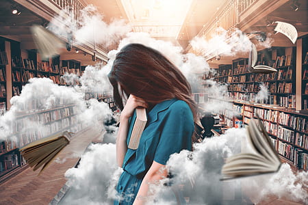 woman holding blue book thumbnail