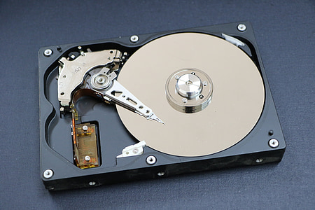 black and beige hard disk drive placed on gray surface thumbnail