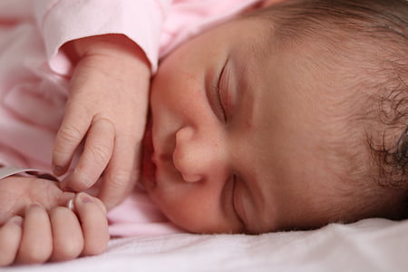 closeup photo of sleeping baby wearing pink top thumbnail