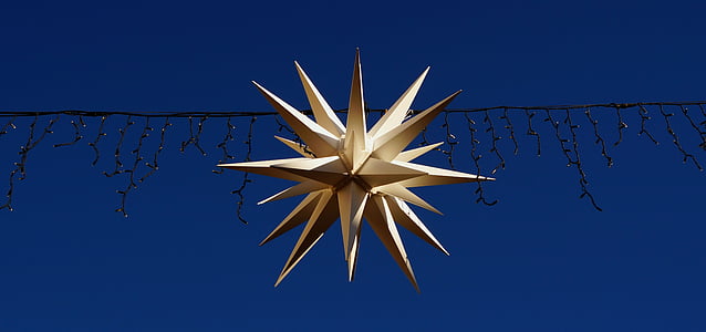 white star lantern hanged on string lights thumbnail