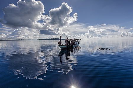boat on body of water with people standing thumbnail