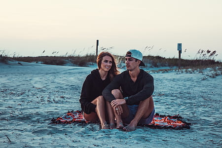 couple sitting on picnic mat thumbnail