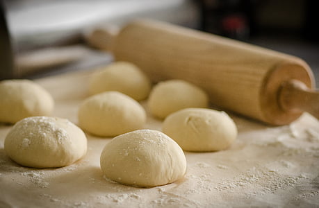 rolling pin beside several doughs thumbnail