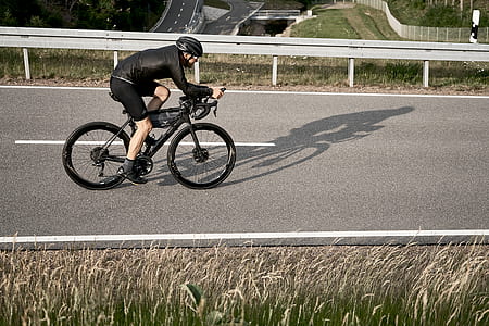 man riding bicycle on asphalt road thumbnail