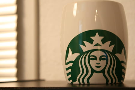 white and green Starbucks mug on black wood thumbnail