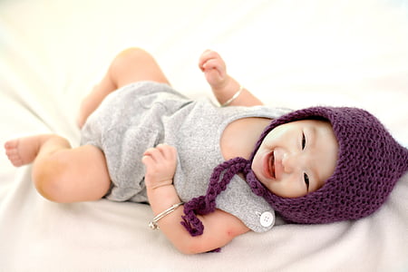 baby wearing purple aviator hat thumbnail