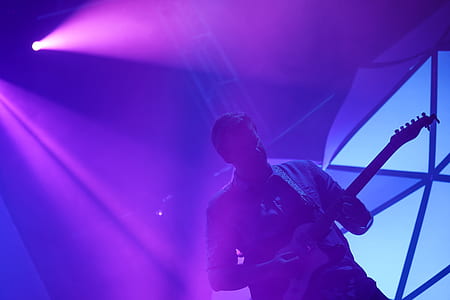 man playing guitar on stage thumbnail