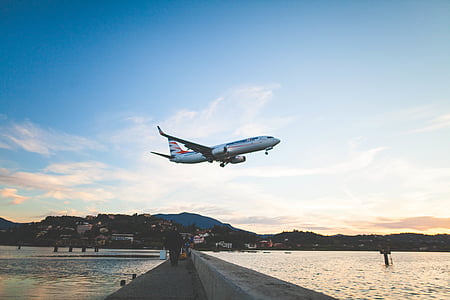 white and blue airplane flying during daytime thumbnail