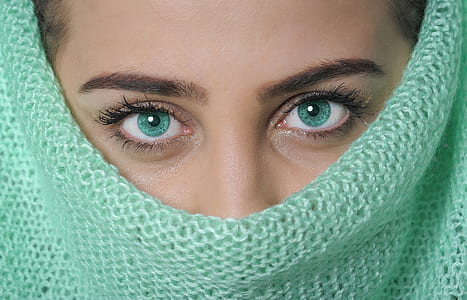 closeup photo of woman with teal knitted outfit thumbnail