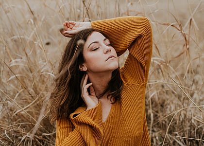 woman in brown sweater at grass field thumbnail