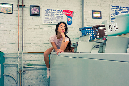 Woman posing in a laundrette thumbnail