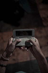 person holding gray Nokia QWERTY phone thumbnail