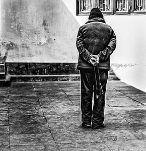 person standing near white painted wall thumbnail