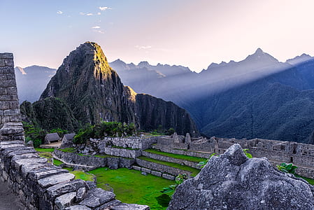 rock formation near mountain range under golden hour thumbnail