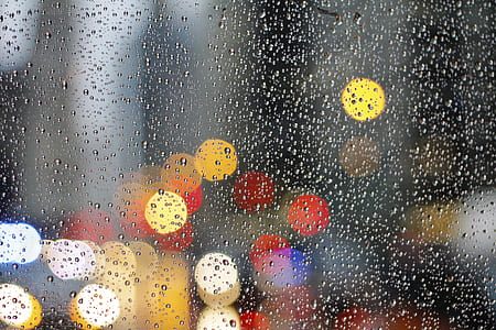 bokeh photography of glass board with dews and lights thumbnail