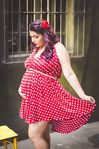 woman wearing white and red polka-dot maternity dress thumbnail