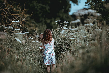 two girls walking in field thumbnail
