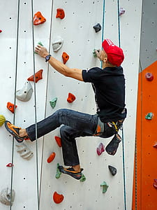 man climbing on white wall thumbnail