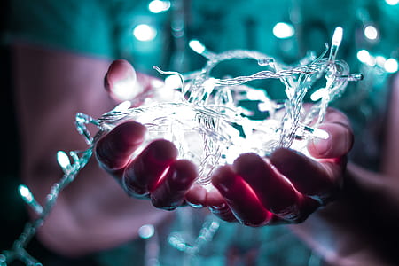 person holding string lights with light thumbnail