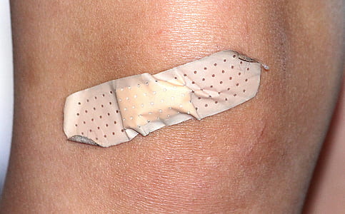 human knee with disposable band aid thumbnail
