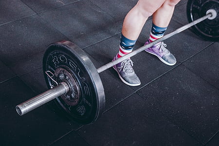 person standing near gray barbell thumbnail