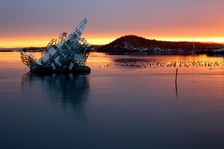 sinking boat during golden hour thumbnail