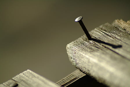 close-up photography of gray nail on brown wooden surface thumbnail