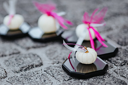 Decorative white pumpkin trinkets with ribbons on the floor thumbnail