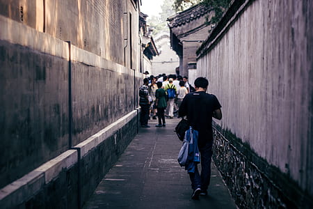 man walking in street corner during daytime thumbnail