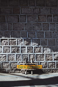 day to day good home signage behind gray bricked wall thumbnail