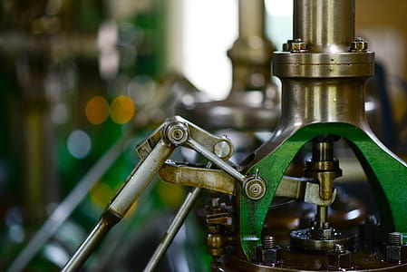 selective focus photography of green and silver metal machine thumbnail