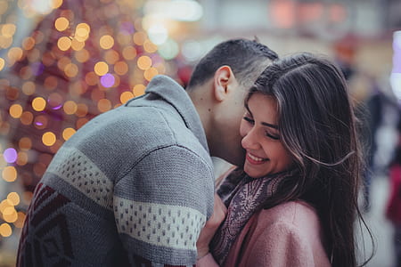 closeup photo of man man kissing the woman in the cheeks thumbnail