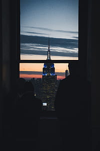 silhouette of two person standing in front of window thumbnail